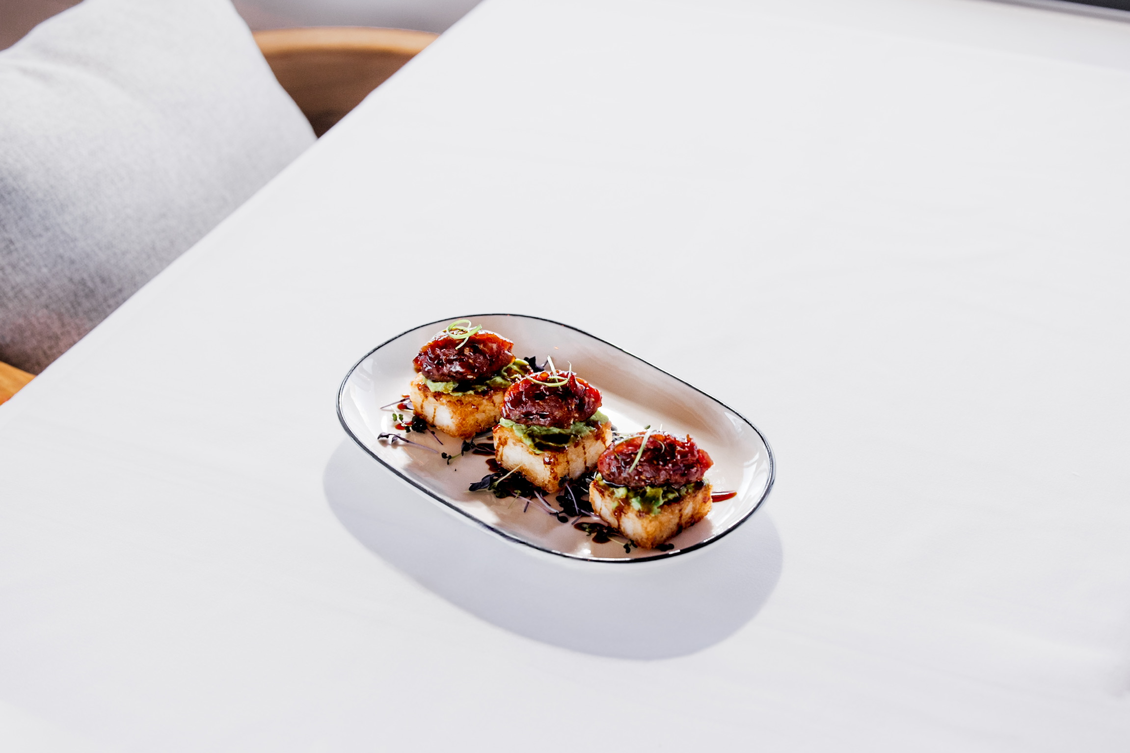 Marinated sushi grade tuna diced and placed on a square of crispy fried rice with avocado and a soy glaze