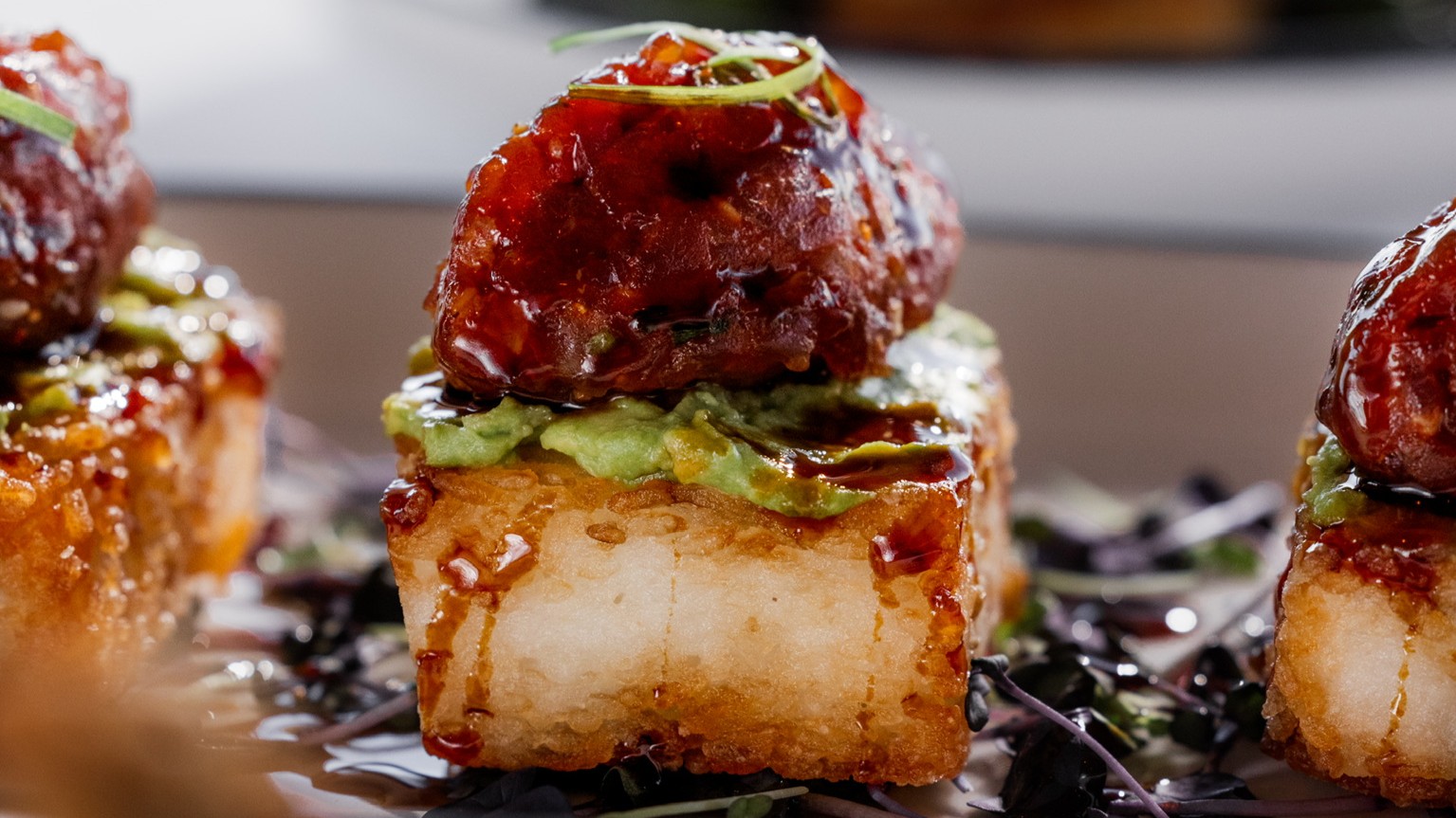 Marinated sushi grade tuna diced and placed on a square of crispy fried rice with avocado and a soy glaze